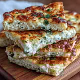 Freshly cooked Fluffy Cottage Cheese Flatbread stacked on a plate, perfect for wraps or dipping.