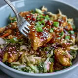 Topped with sesame seeds, green onions, and a drizzle of chili crisp for a satisfying crunch at dinner.