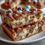 Cadbury Egg Cookie Bars with Pastel M&Ms: Soft, chewy bars loaded with Cadbury mini eggs and colorful M&Ms for a festive Easter dessert.