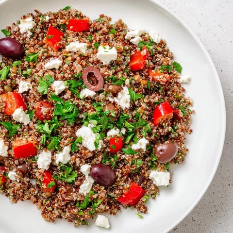 This hearty Greek Power Salad features colorful veggies, creamy feta, and a tangy olive oil dressing over a bed of grains.  