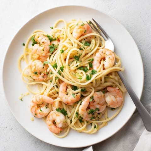 Fork-tender shrimp in a rich garlic butter sauce, served over al dente linguine with lemon juice.