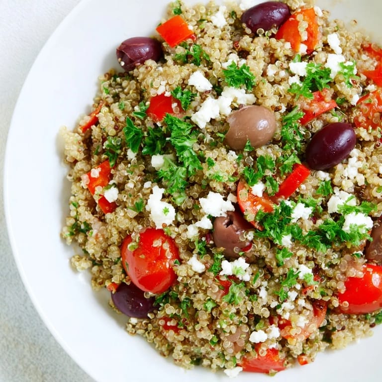 Tossed Greek Power Salad with cherry tomatoes, cucumbers, olives, and herbs, perfect for a nutritious, protein-packed Mediterranean lunch.