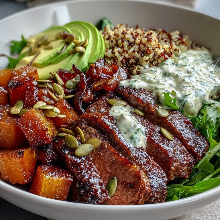 Butternut squash steak bowls feature caramelized cubes, tender beef slices, and a drizzle of zesty lime dressing.