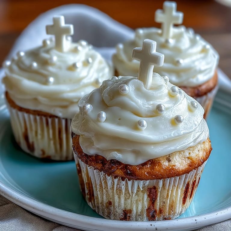 Vanilla Communion Cupcakes crowned with creamy frosting and elegant white fondant crosses.