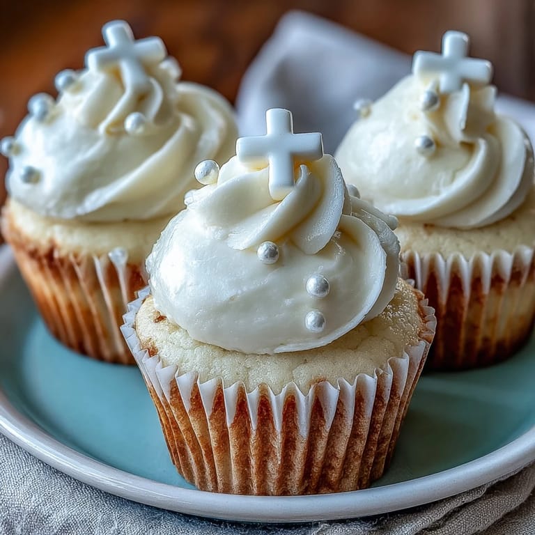 Tender Communion Cupcakes adorned with a sweet vanilla buttercream and a devotional cross.