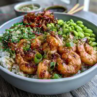 Grilled Asian shrimp bowl with jasmine rice, crisp veggies, and a drizzle of ginger-sesame dressing.