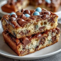 Cadbury Egg Cookie Bars with Pastel M&Ms: Soft, chewy bars loaded with Cadbury mini eggs and colorful M&Ms for a festive Easter dessert.