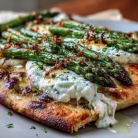 Roasted Asparagus Flatbread with Burrata, bright with lemon and basil.